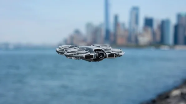 Compact DJI Neo 2 concept drone flying above a waterfront city skyline