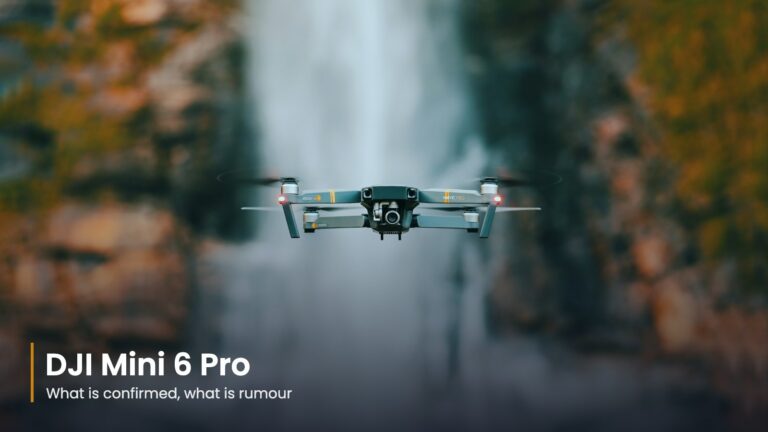 Small camera drone hovering in front of a waterfall