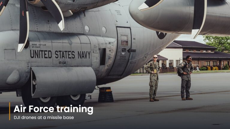 Two service members beside a military transport aircraft